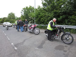 Ted Robinson checks his route card with other machines and riders in the background.